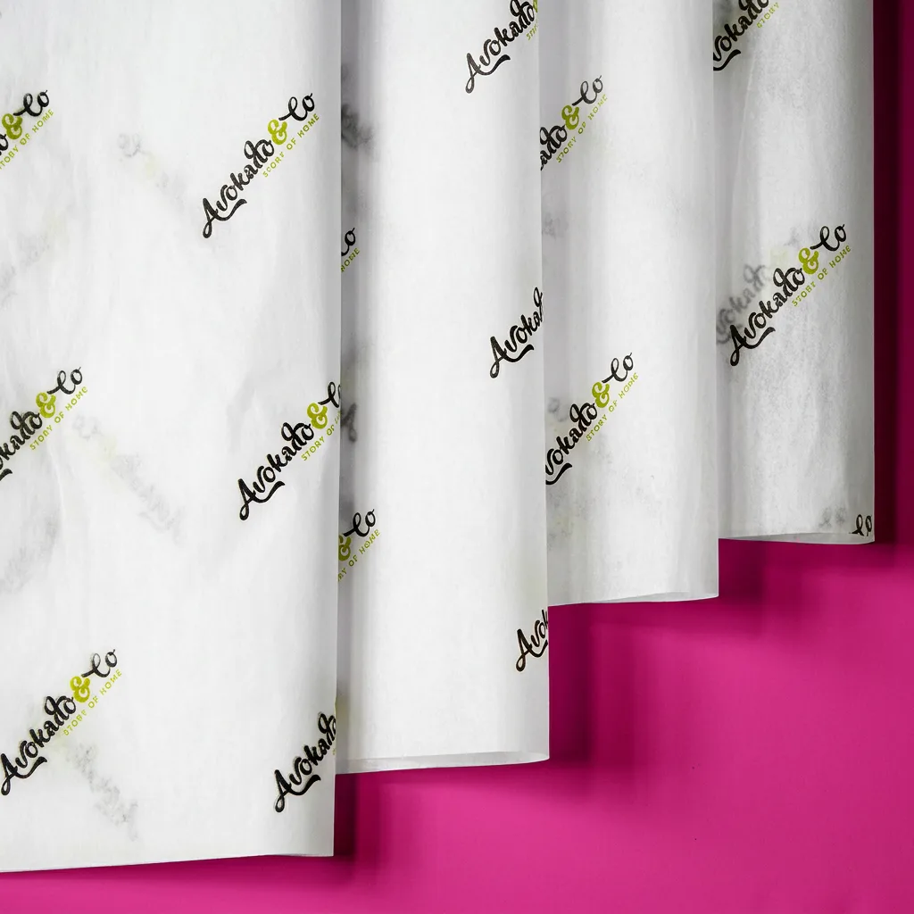 Custom tissue paper with gold logo print on pink background for branded packaging