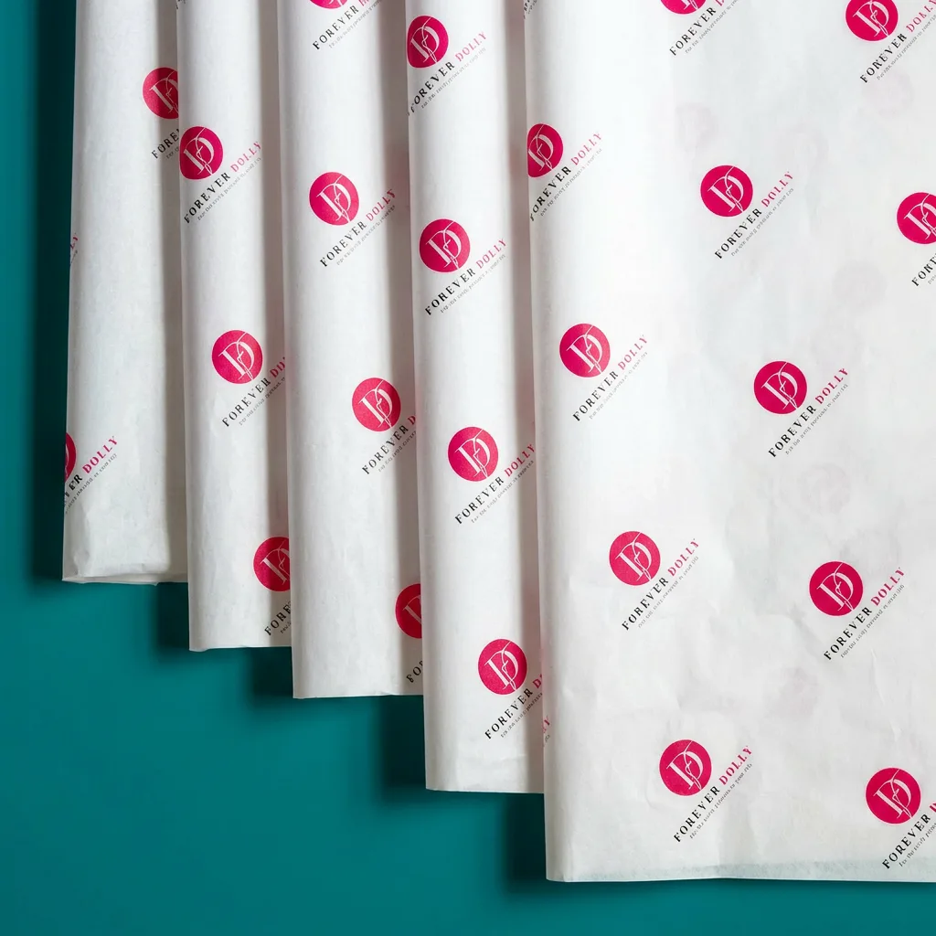 Personalised tissue paper with repeated logo pattern in pink and white